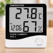 Цифровий термометр-гігрометр HTC-1 з годинником — товар у студійній композиції